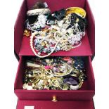 A maroon tray fitted jewellery box containing a quantity of assorted costume jewellery
