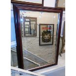 A modern stained wood framed bevelled oblong wall mirror