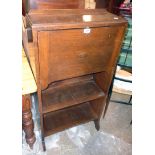 A 24" early 20th Century stained oak lady's bureau with part fitted interior and two open shelves