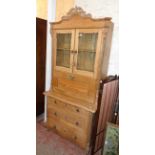 A 3' 3" continental pitch pine secretaire chest with pierced pediment, flanking applied