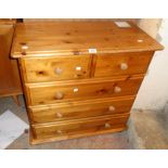 A 32" modern polished pine chest of two short and three long drawers, set on bun feet