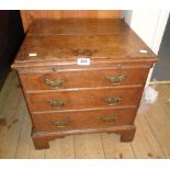 A 19" antique oak lift-top chest with dummy slide and triple drawer fronts, set on bracket feet