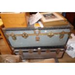Two vintage brass and iron bound metal clad travelling trunks