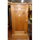 A 15 1/2" waxed pine bedside cabinet with gallery to top and panelled door, set on plinth base