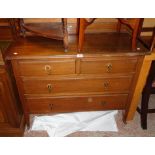 A 3' 6" Edwardian oak chest of two short and two long graduated drawers, set on square tapered