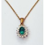 A marked 9ct yellow metal emerald and diamond pendant, on similarly marked chain