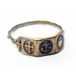 An antique yellow metal ecclesiastical ring decorated with central anchor motif flanked by sacred