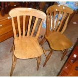 Two pairs of 20th Century Windsor style kitchen chairs with moulded solid elm seats, set on turned