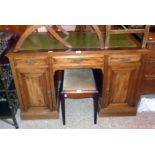 A 4' Edwardian mahogany knee-hole desk with green leather inset top, three frieze drawers and