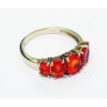 An import marked 375 gold ring, set with five orange coloured stones