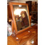 A Victorian mahogany platform dressing table mirror with serpentine base, set on bun feet