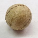 An old stitched leather golf ball