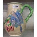A Clarice Cliff (Newport Pottery) ribbed bulbous jug with raised polychrome perching budgerigar