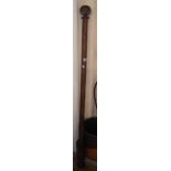 A 6' 4" (overall) stained wood curtain pole with pommel terminals and wooden rings