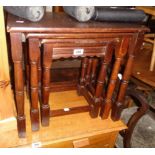 A nest of three 20th Century stained oak tea tables