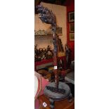 An early 20th Century Chinese rosewood gong stand with carved dragon pattern top and circular base