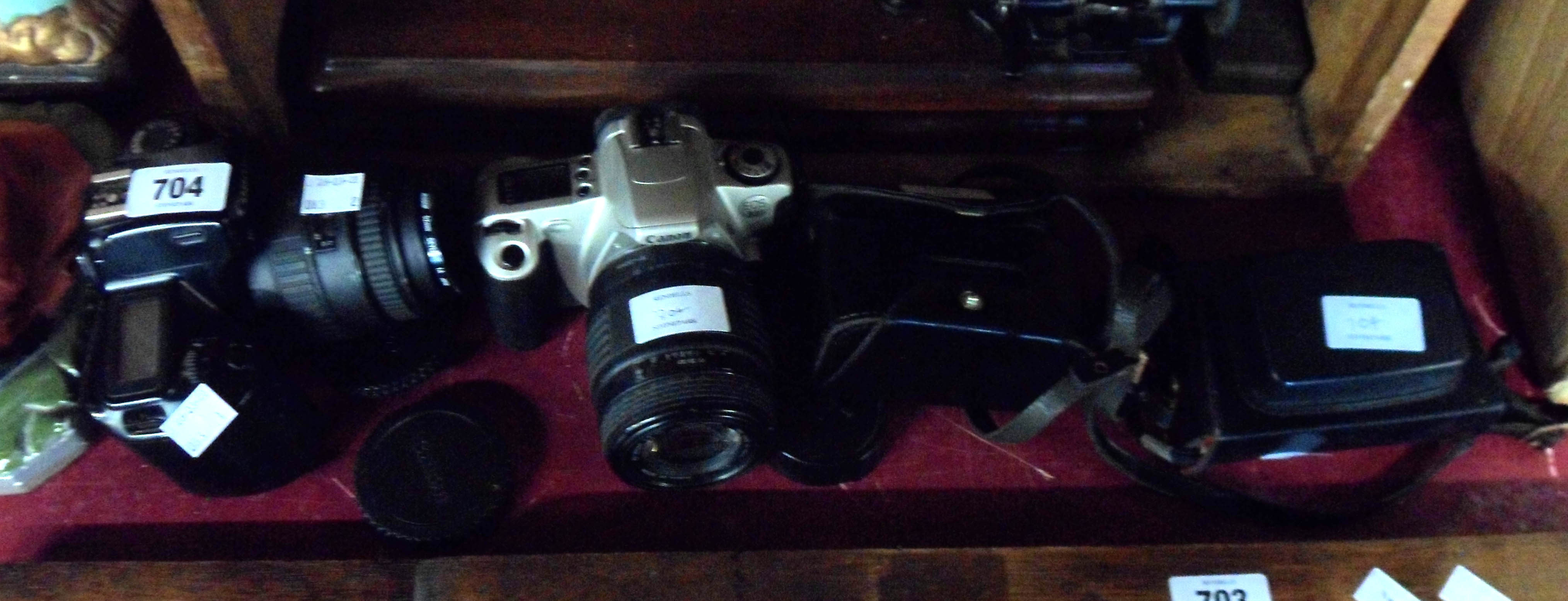 A Canon EOS 100 35mm camera, a Canon EOS 700 35mm camera - sold with two Kodak cameras