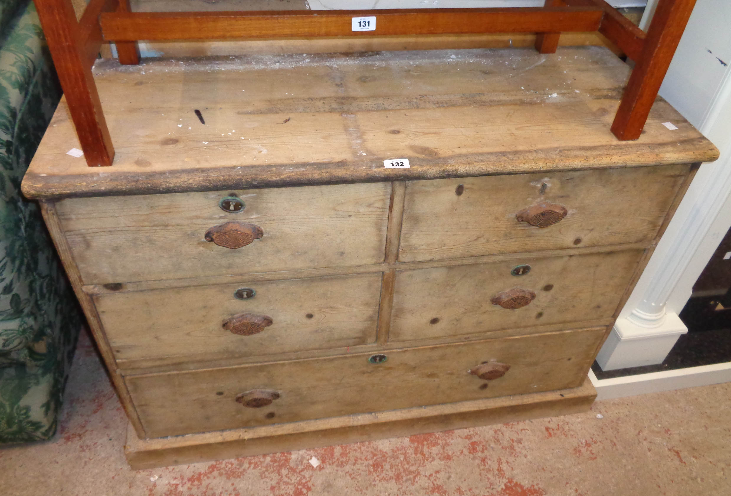 A 3' 6" old stripped pine chest of four short and one long drawer, set on plinth base - a/f