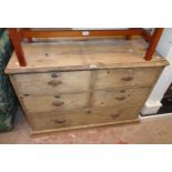 A 3' 6" old stripped pine chest of four short and one long drawer, set on plinth base - a/f