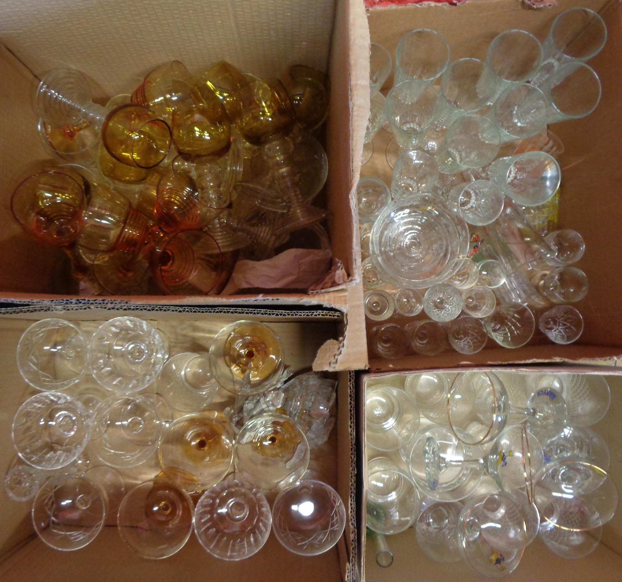 Four boxes containing a large quantity of drinking glasses including Edinburgh Crystal, Babycham,