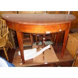 A 4' antique mahogany demi-lune side table with stringing to apron edge, set on square tapered