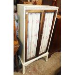 A 23 3/4" early 20th Century book cabinet with later painted finish, the glazed doors replaced