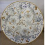 A Coalport blank plate with hand painted Rococo swags and armorial decoration by Georgiana E.