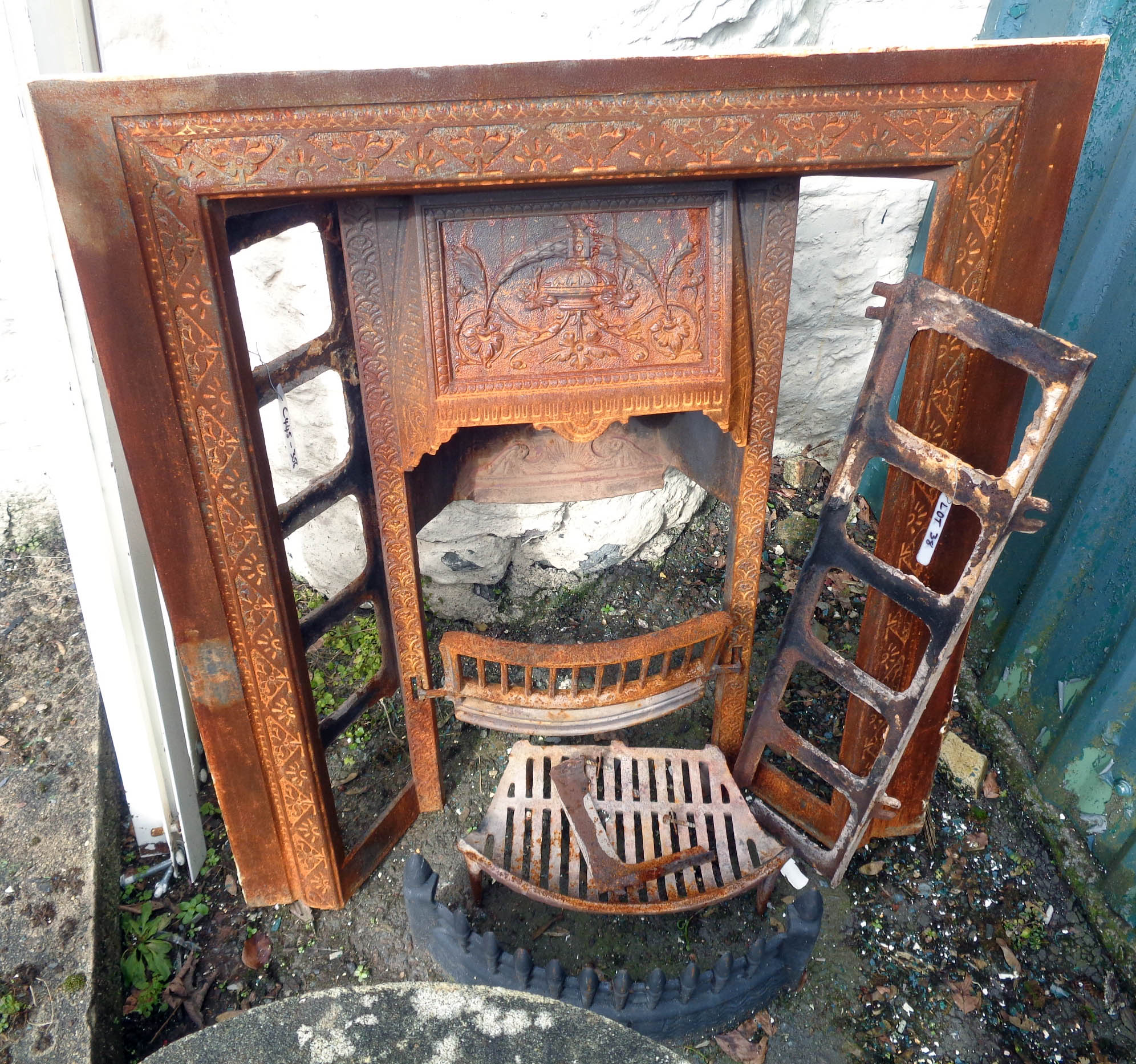 A cast iron fire place insert and grate