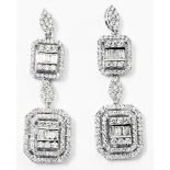 A pair of marked 18k white metal Art Deco style double drop ear-rings encrusted with baguette and