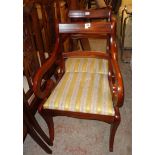 Four matching reproduction mahogany framed sabre leg dining chairs comprising two carvers and two