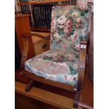 A mid 20th Century Be-at-ees American style rocking armchair with stained oak part show frame and