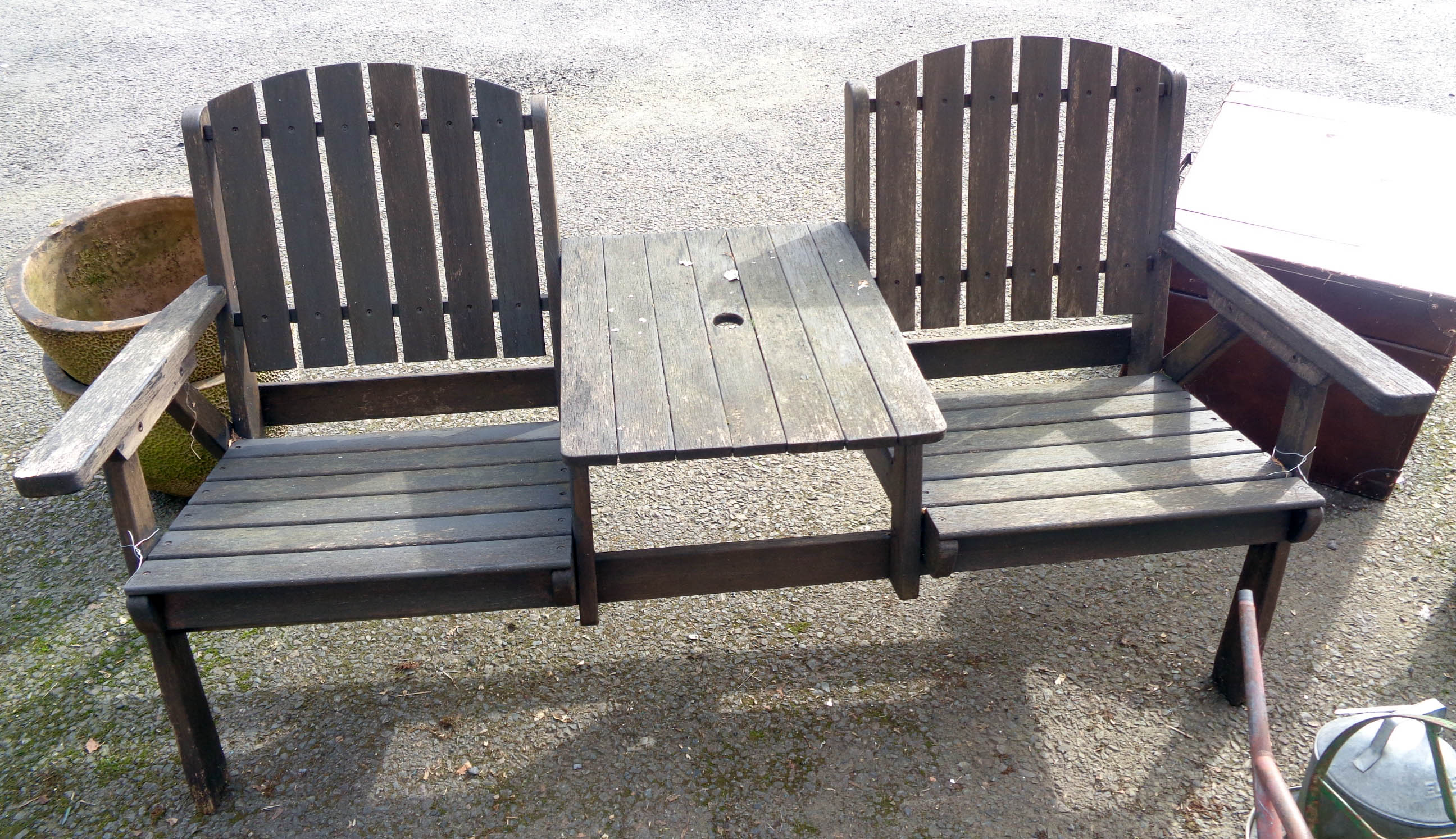 A two seater garden bench with central table