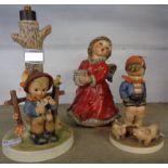 A Hummel lamp base, one musical figure and two others