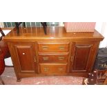 A 5' early 20th Century mahogany sideboard with three central drawers and panelled cupboard doors,