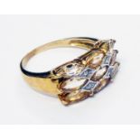 A hallmarked 375 gold ring, set with nine marquise cut pale citrine stones and four tiny diamonds