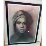 A large framed monochrome charcoal and pencil portrait of a woman wearing a head scarf