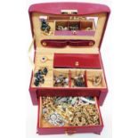 A maroon travelling jewellery case containing a quantity of assorted costume jewellery