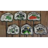 A set of six painted cast iron vegetable labels