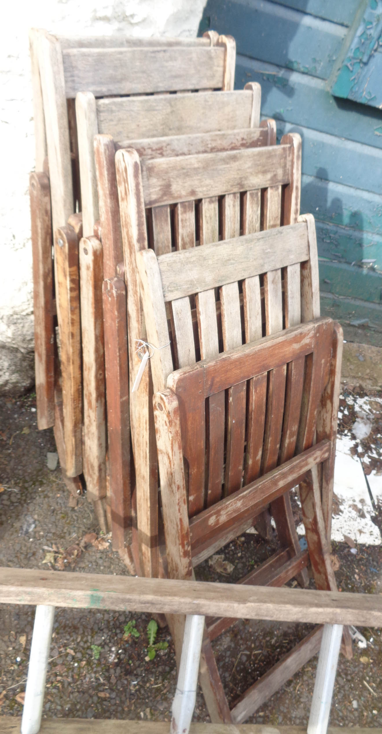 A set of six teak folding chairs