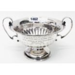 A 6 3/4" diameter silver trophy rose bowl with flanking cast scroll handles, engraved presentation