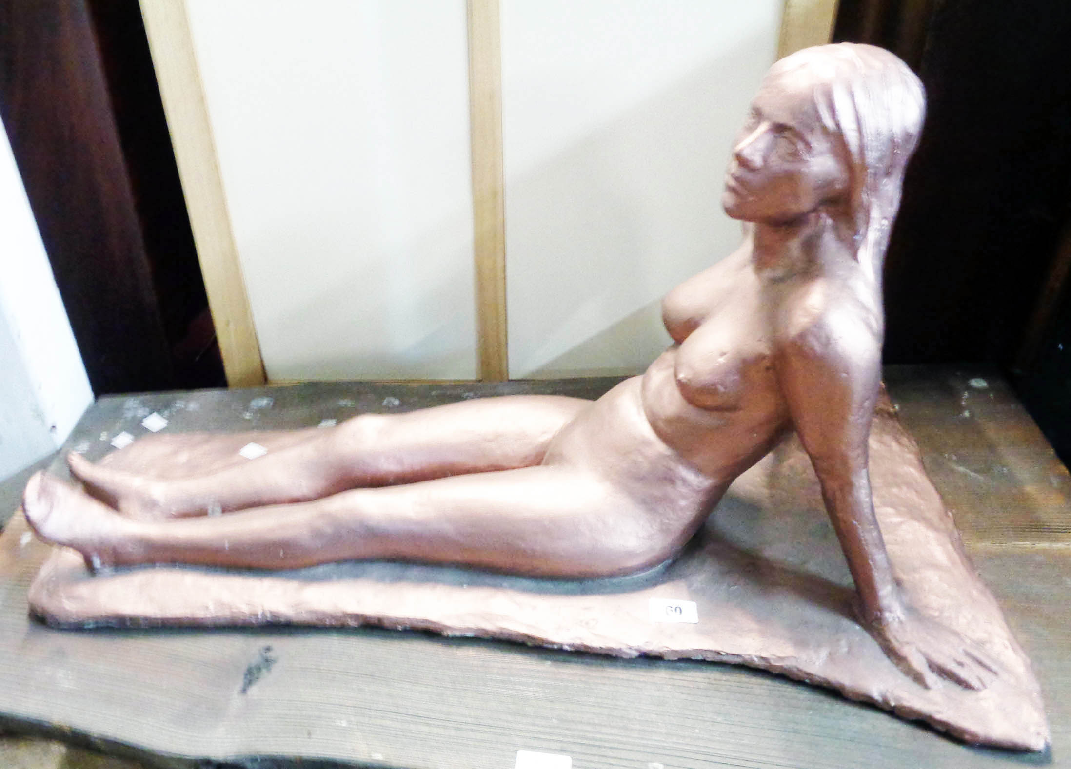 A large bronzed composite sculpture of a nude female figure