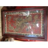 A large framed and glazed antique Oriental silk hanging, decorated with lions in metal and