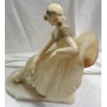 A 1920`s carved alabaster statue of a lady sat on a large chair, with painted decoration and