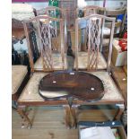 A set of four early 20th Century stained walnut and strung high back standard chairs with decorative