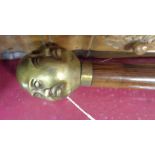 A modern reproduction walking stick with four faced Buddha top