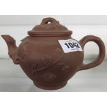 A 20th Century Chinese Yixing zishi terracotta teapot with prunus decoration