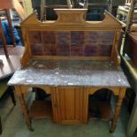A 3' 6" Edwardian satin walnut washstand with tile set splash back and brown marble top, over
