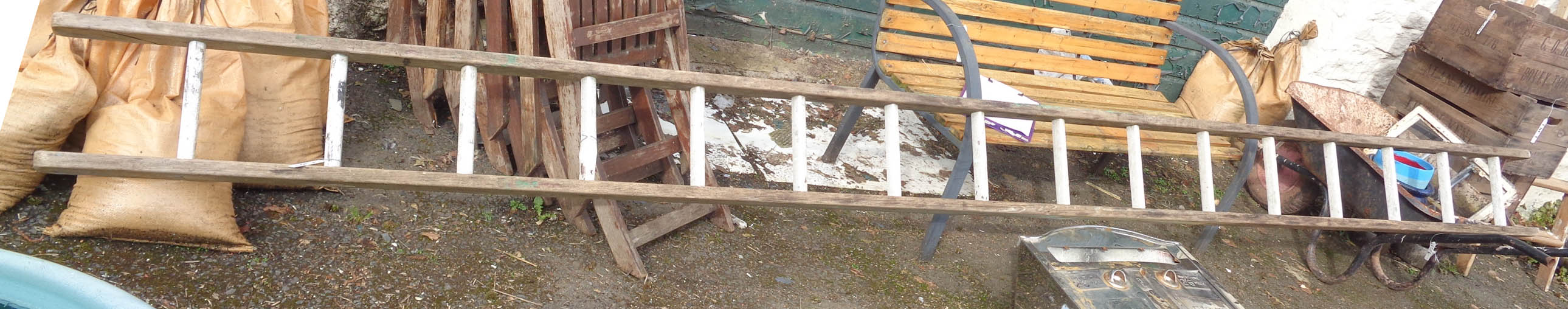 A long wooden ladder with metal treads