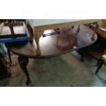 A late Victorian mahogany extending dining table with single leaf, set on heavy cabriole legs with