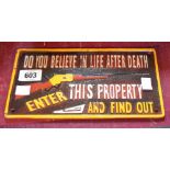 A modern reproduction painted cast iron Trespass sign